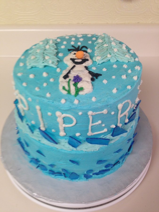 Light blue Frozen themed birthday cake with an Olaf drawing and icy decorations